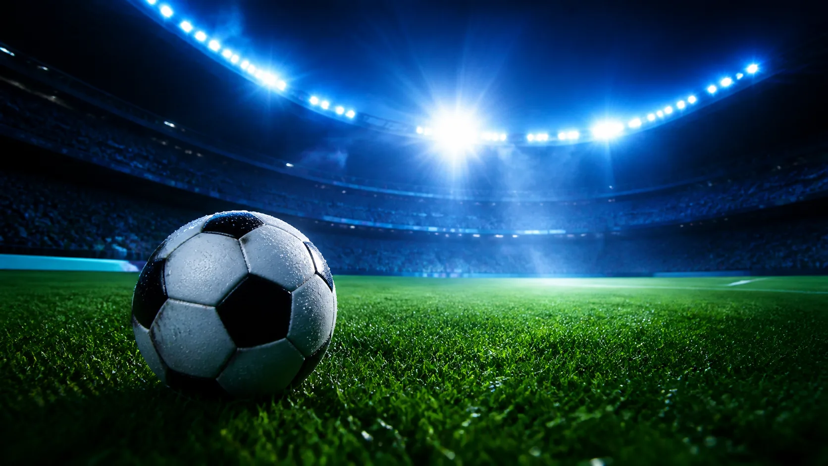 Bola de futebol em um estádio iluminado